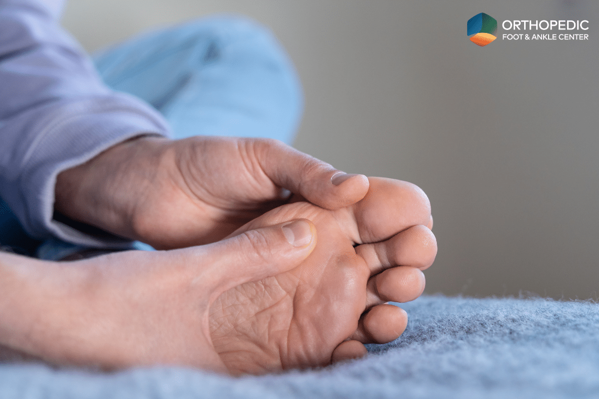 A man with turf toe holding his foot in pain in Ohio.